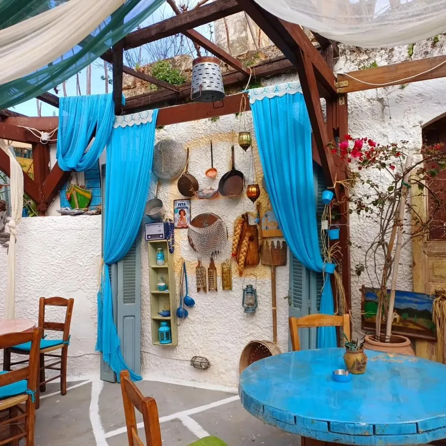 Restaurant exterior with blue curtains and kitchen utensils